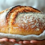 Cadmio en el pan: pan artesanal en manos, ejemplo de alimento básico en la dieta diaria con posible exposición a metales pesados